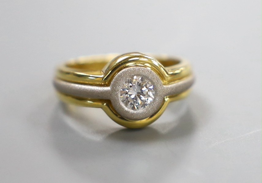 A modern 18ct two colour gold and solitaire diamond set ring, with sand blasted band, size L, gross weight 6.2 grams